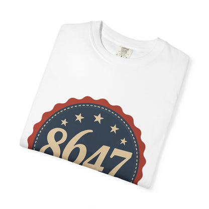 8647 DJT He's Gotta Go Unisex Garment-Dyed Tee. Large front logo design