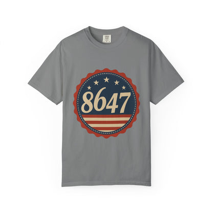 8647 DJT He's Gotta Go Unisex Garment-Dyed Tee. Large front logo design